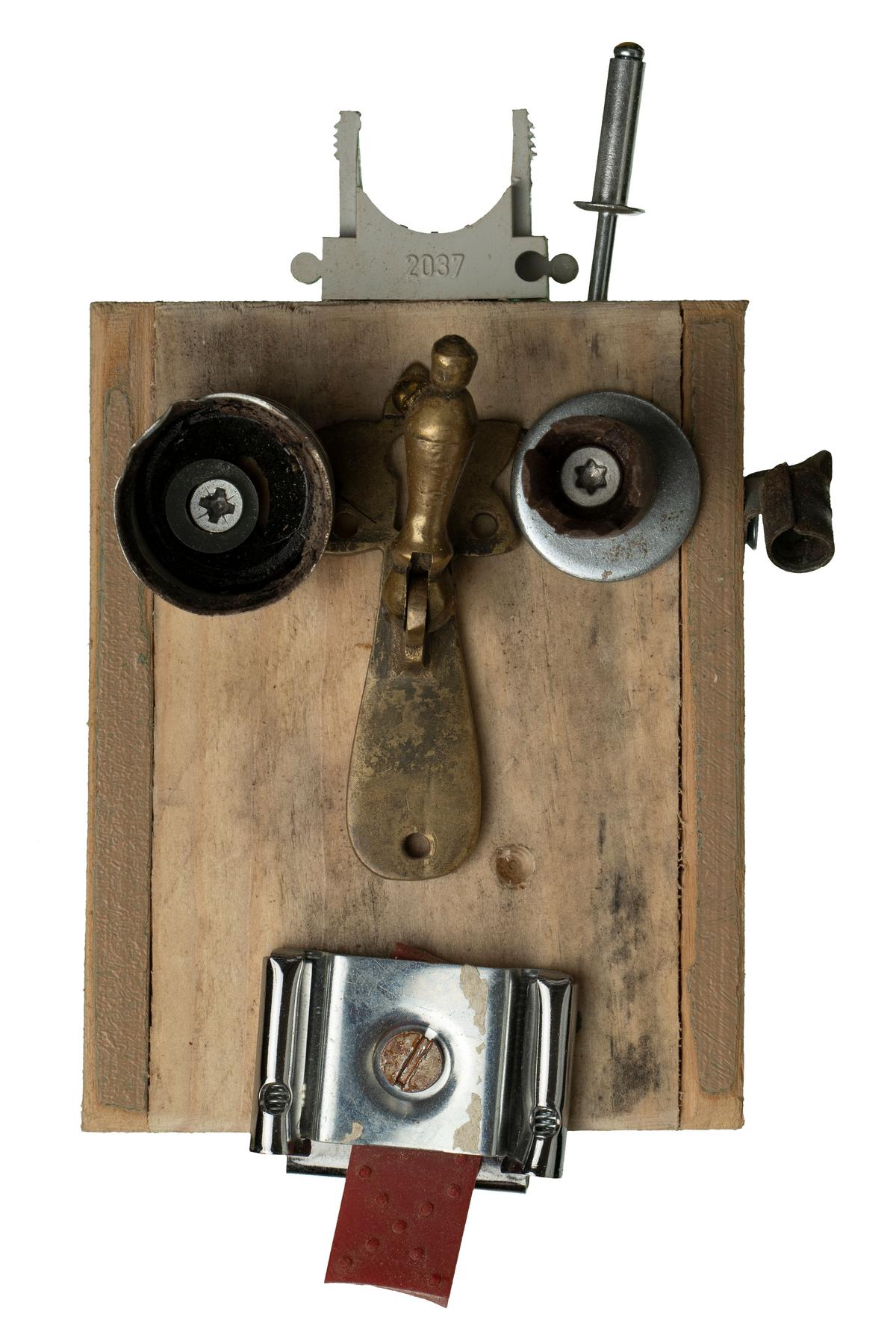 Robotic head made of wood and various small industrial parts isolated on the white background